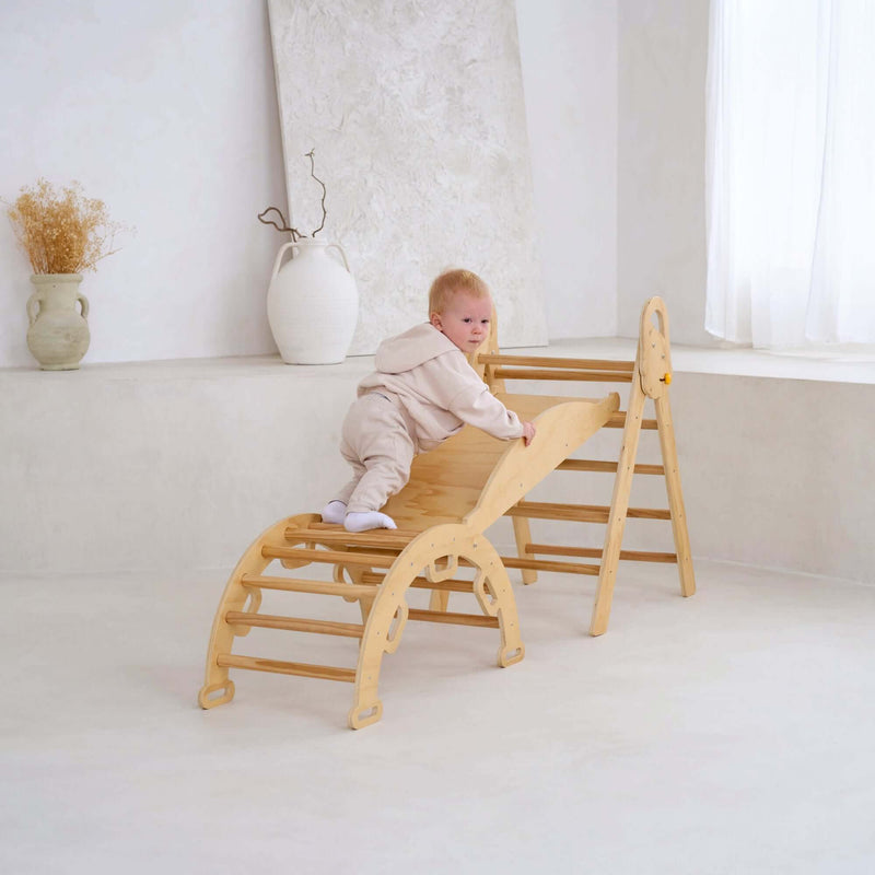 Toddler climbing up the montessori 3 in 1 wooden activity climbing set in a minimalistic room | Toys | Indoor Play Equipment  | Climbing Frames - Clair de Lune UK