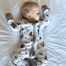 Sleeping boy wearing the GrowGrows Organic Cozy Cubs Sleepsuit in the nursery | Baby Grows and Onesies | Organic Baby Clothes - Clair de Lune UK