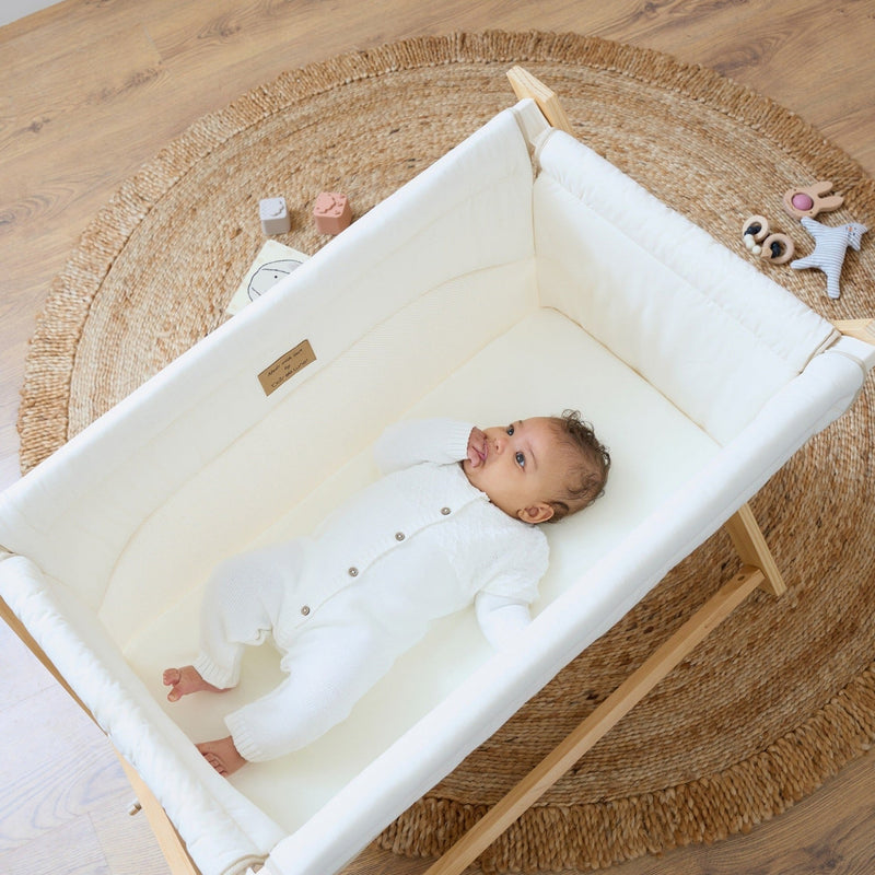 Baby playing in the Organic Folding Crib | Bedside Cribs & Folding Cribs | Next To Me Cots & Newborn Baby Beds | Co-sleepers - Clair de Lune UK