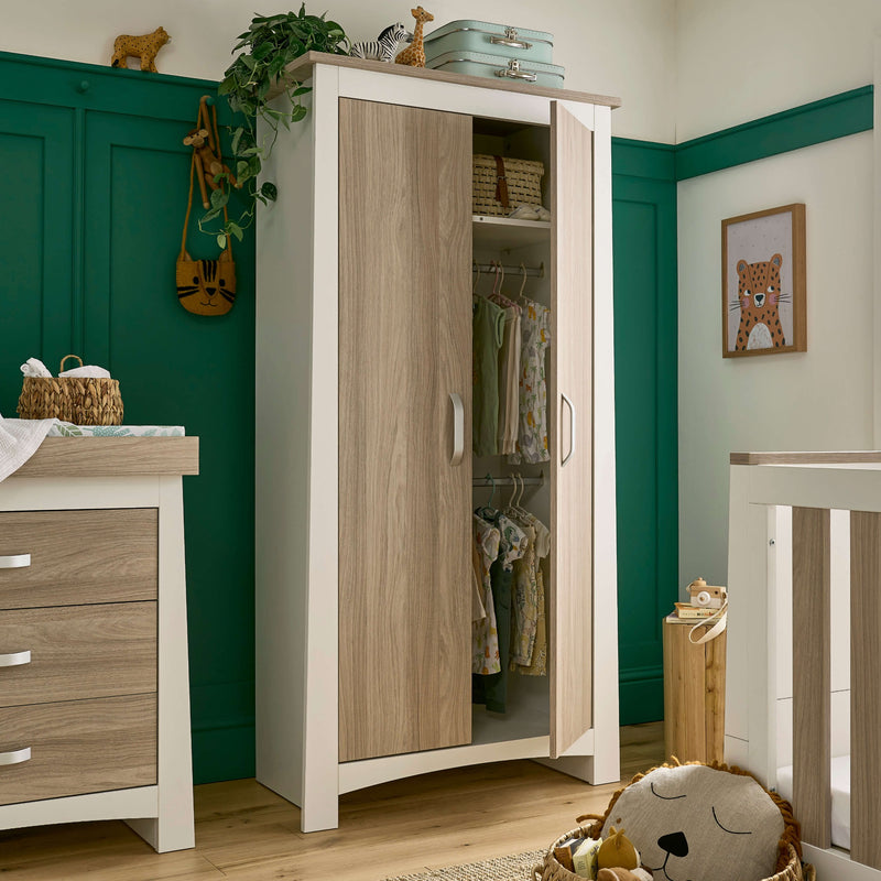 White and Natural Double Wardrobe from the CuddleCo Ada Cot Bed & Nursery Room Sets with baby clothes in a trendy green nursery room | Nursery Furniture Sets | Room Sets | Nursery Furniture - Clair de Lune UK