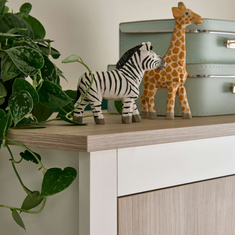 The natural wood details of the White and Natural Double Wardrobe from the CuddleCo Ada Cot Bed & Nursery Room Sets in a trendy green nursery room | Nursery Furniture Sets | Room Sets | Nursery Furniture - Clair de Lune UK