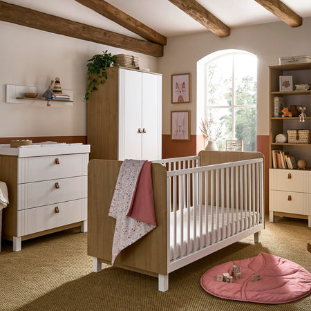 The 5-Piece Room Set including a white and natural cot bed, a matching double wardrobe, a matching bookcase, a matching dresser and a matching shelf from the White and Natural CuddleCo Rafi Nursery Room Sets in a Biritsh countryside cottage nursery room |