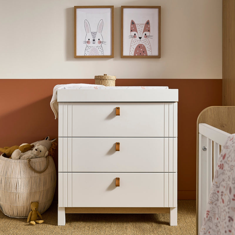 White and Natural CuddleCo Rafi Changing Unit in a dark orange nursery room | Baby Bath & Changing Units | Baby Bath Time - Clair de Lune UK