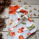 Grow Grows Organic Autumnal Amazes Pyjamas folded on wooden floor with pinecones | Organic Kids PJs and Nightwear - Clair de Lune UK