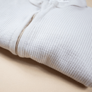 Cashmere Grow Grows Organic Ribbed Baby Sleepsuit folded on white background | Baby Sleep Wear | Children's pyjamas - Clair de Lune UK