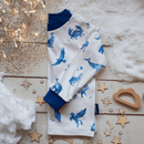 Grow Grows Cosmic Constellations Pyjamas top folded on a wooden floor with star confetti | Organic Kids PJs and Nightwear - Clair de Lune UK