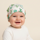 Baby smiling at the camera wearing the GrowGrows Cuddly Cacti Baby Hat | Bamboo Babywear - Clair de Lune UK
