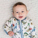 Baby smiling wearing the Grow Grows Organic Dandy Dinos Sleepsuit | Baby Grows and Onesies | Organic Baby Clothing - Clair de Lune UK