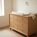 Dash Anti-Roll Wedge Baby Changing Mat on an oak changing unit in a minimal beige nursery | Baby Bath Time Essentials - Clair de Lune UK