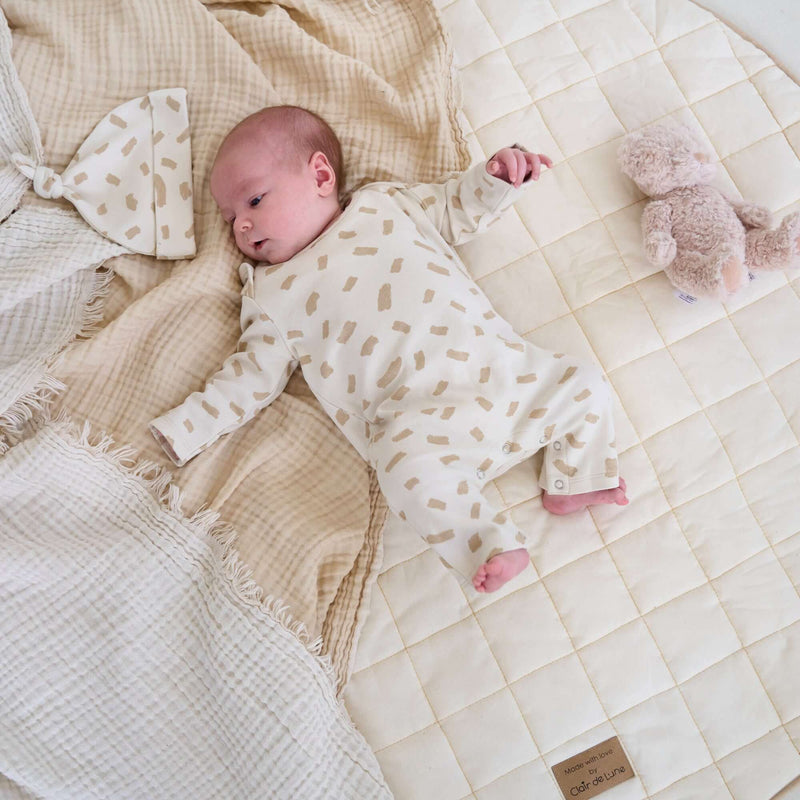 Newborn lying on the Organic Play Mat wearing the Dash Baby Grow and Hat from the Little Dreamers Luxury Organic Gift Set  | Newborn Gift Set | Baby Grow | Organic Nursery Range - Clair de Lune UK