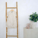 TheLittle Dreamers Luxury Organic Swaddle Bag on a wooden ladder against a white wall with a plant and teddy bear in the background | Baby Swaddle Bag | Newborn Sleeping Bag | Nursery Bedding - Clair de Lune