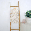 The Little Dreamers Luxury Organic Swaddle Bag on a wooden ladder against a white wall with a plant and teddy bear in the background | Baby Swaddle Bag | Newborn Sleeping Bag | Nursery Bedding - Clair de Lune