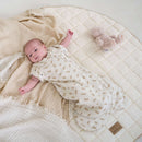 Newborn baby wearing the luxury organic swaddle bag on the Organic Play Mat in White | Baby Play Mat | Baby & Toddler Toys & Gifts - Clair de Lune UK