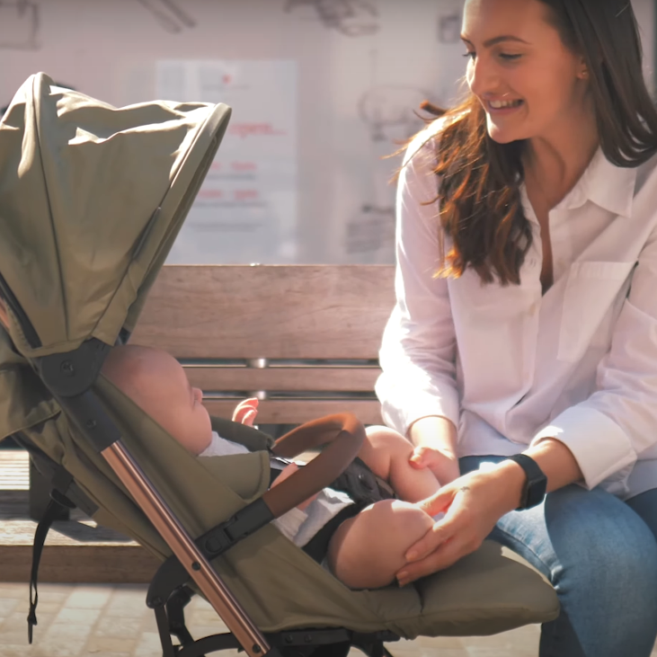 Mum looking at her kid sleeping in the Didofy Green New Aster 2 Ultra-Compact Pushchair & Travel System | Didofy | Pushchairs and Travel Systems | Baby & Kid Travel - Clair de Lune UK