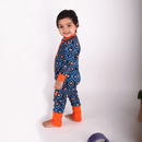 Toddler stood wearing the GrowGrows Organic Feather Flames Sleepsuit | Baby Grows and Onesies | Organic Baby Clothes - Clair de Lune UK