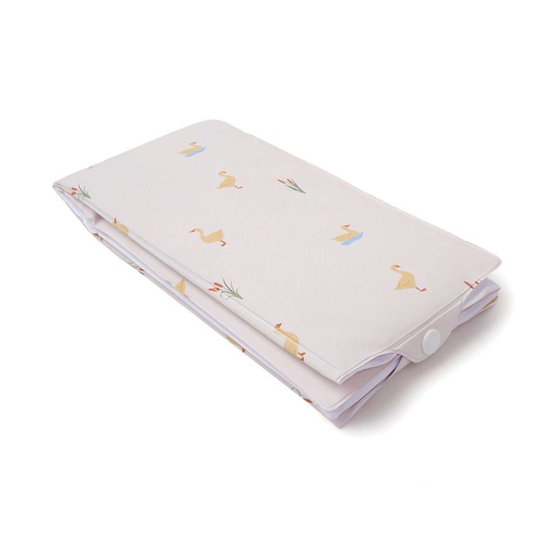 Folded Duckling Foldable Travel Changing Mat with a close-up of the snap fastening | Bathing & Changing Essentials - Clair de Lune  UK