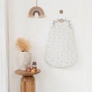 Little Duckling Sleeping Bag (0-6 Months) hanging on a hook by a wooden stool and vase in nursery | Swaddles and Sleep Bags | Baby Bedding | Nursery Accessories - Clair de Lune UK