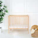 Natural East Coast Space Saver Cot  with mini mattress in a white nursery with play basket | Cots, Cot Beds & Toddler Beds | Nursery Furniture - Clair de Lune UK