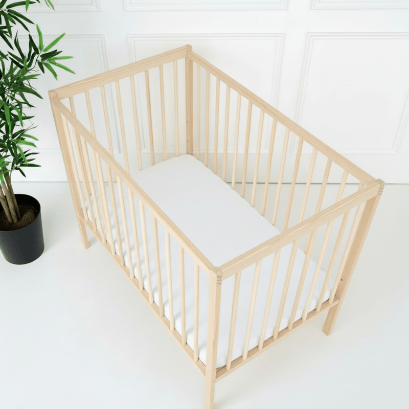 Natural East Coast Space Saver Cot with mini mattress in a white nursery with East Coast 2 Pack Space Saver Cot Sheets | Cots, Cot Beds & Toddler Beds | Nursery Furniture - Clair de Lune UK