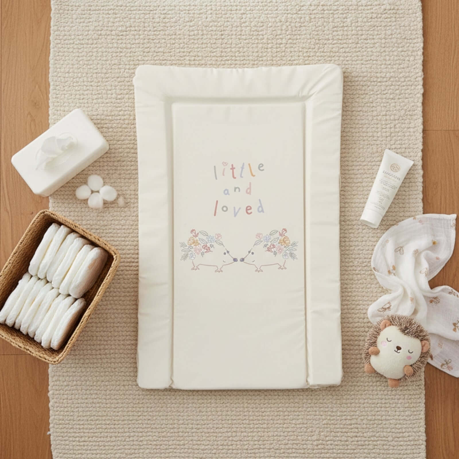 East Coast Little & Love Changing Mat laid flat on a cream rug with nappies and muslin | Bathing & Changing Essentials - Clair de Lune UK