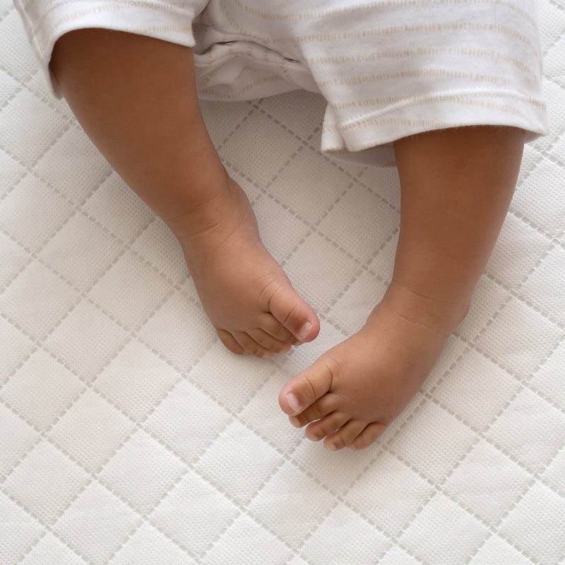 Baby sleeping on the Essentials Hypoallergenic Fibre Cot Bed Mattress (140 x 70 cm) | Cot Bed Mattresses (140x70cm) | Baby Mattresses | Bedding | Nursery Furniture - Clair de Lune UK
