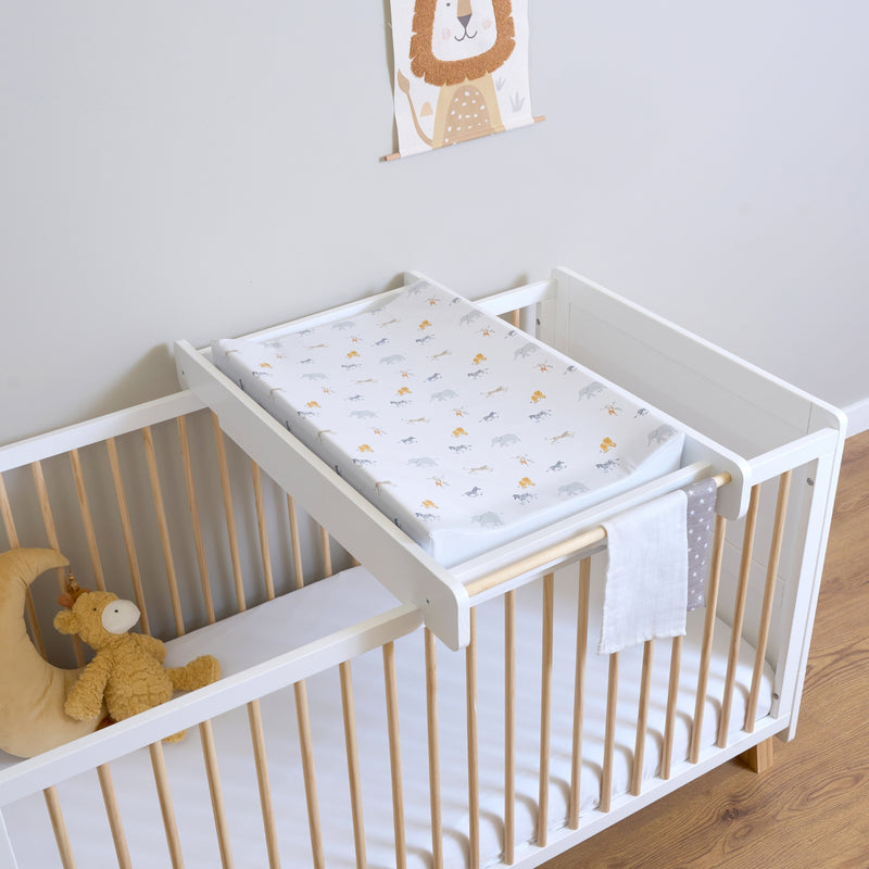 White Essentials Cot Bed with the Essentials Cot Top Changer in a sage green Scandi nursery room | Cots, Cot Beds & Toddler Beds | Nursery Furniture - Clair de Lune UK