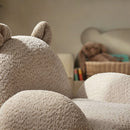 Bear CuddleCo Etta Kids Chair Boucle | Toddler Arm Chair close up in a cosy corner of the nursery with a book and teddy | Children's Furniture - Clair de Lune UK