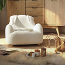 Bunny CuddleCo Etta Kids Chair Boucle in a cosy corner of the nursery with a book and teddy | Toddler Arm Chair | Children's Furniture - Clair de Lune UK