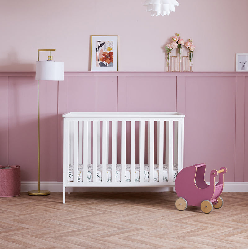 The cot bed of White Obaby Evie Mini 3 Piece Room Set in a pastel pink Disney princess-theme nursery room | Nursery Furniture Sets | Room Sets | Nursery Furniture - Clair de Lune UK