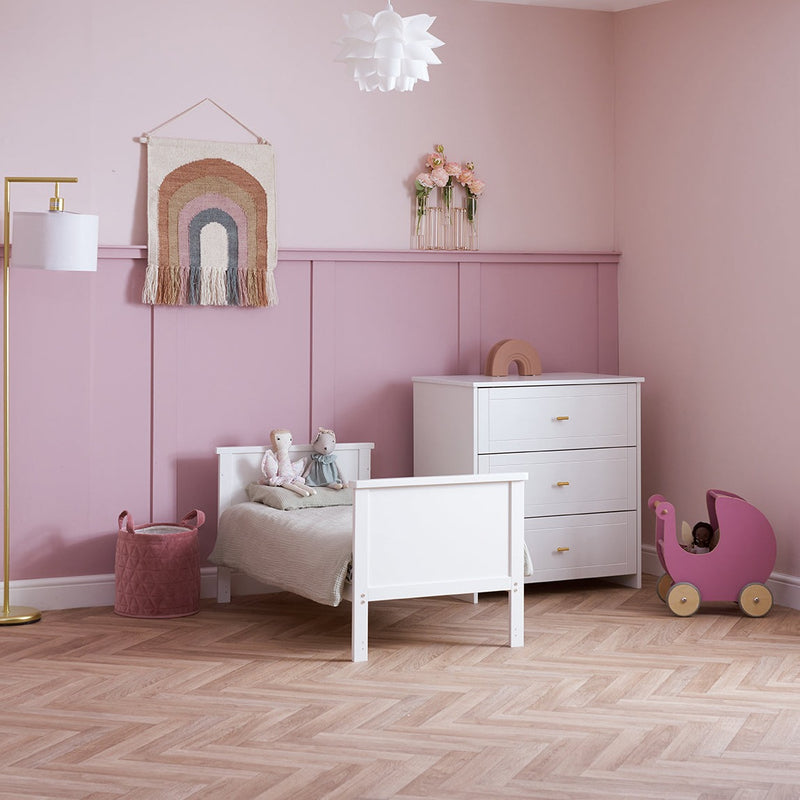 The cot bed and changer of the White Obaby Evie Mini 3 Piece Room Set in a pastel pink Disney princess-theme nursery room | Nursery Furniture Sets | Room Sets | Nursery Furniture - Clair de Lune UK