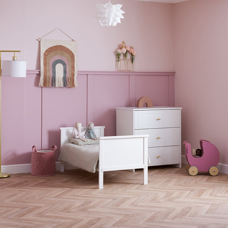 White Obaby Evie Mini Cot Bed in a pastel pink Disney princess-theme nursery room next to the Evie changer | Cots, Cot Beds, Toddler & Kid Beds | Nursery Furniture - Clair de Lune UK