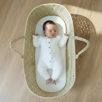 Baby lying on the Hypoallergenic Fibre Palm Moses Basket Mattress | Moses Basket Mattresses | Moses Baby Basket Accessories | Nursery Bedding - Clair de Lune UK