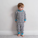Boy stood by a wall wearing the Grow Grows Organic Delightful Doodles Pyjamas | Organic Kids PJs and Nightwear - Clair de Lune UK