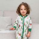 Toddler stood by the sofa n the living room Toddler wearing the Grow Grows Organic Alpine Adventures Sleepsuit | Baby Sleepsuits and Baby Grows | Organic Baby Clothing - Clair de Lune UK