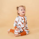 Toddler girl wearing the GrowGrows Organic Gentle Giraffes Sleepsuit | Baby Grows and Onesies | Organic Baby Clothes - Clair de Lune UK