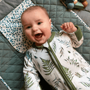 Baby smiling wearing the Grow Grows Organic Country Leaf Sleepsuit | Baby Grows and Onesies | Organic Baby Clothes - Clair de Lune UK