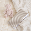 Brown Gingham Foldable Travel Changing Mat packed up on an organic play pad | Baby Change Mats | Bathing & Changing Essentials - Clair de Lune UK