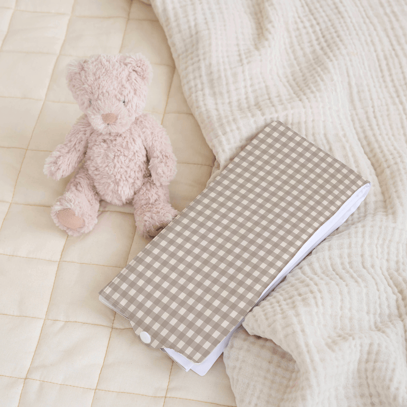 Brown Gingham Foldable Travel Changing Mat packed up on an organic play pad | Baby Change Mats | Bathing & Changing Essentials - Clair de Lune UK