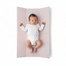 Baby lying on the Brown Gingham Anti-Roll Wedge Baby Changing Mat on a white background | Baby Bath Time Essentials - Clair de Lune UK