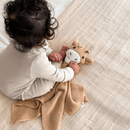 Baby holding the GrowGrows Giraffe Comforter - Clair de Lune UK
