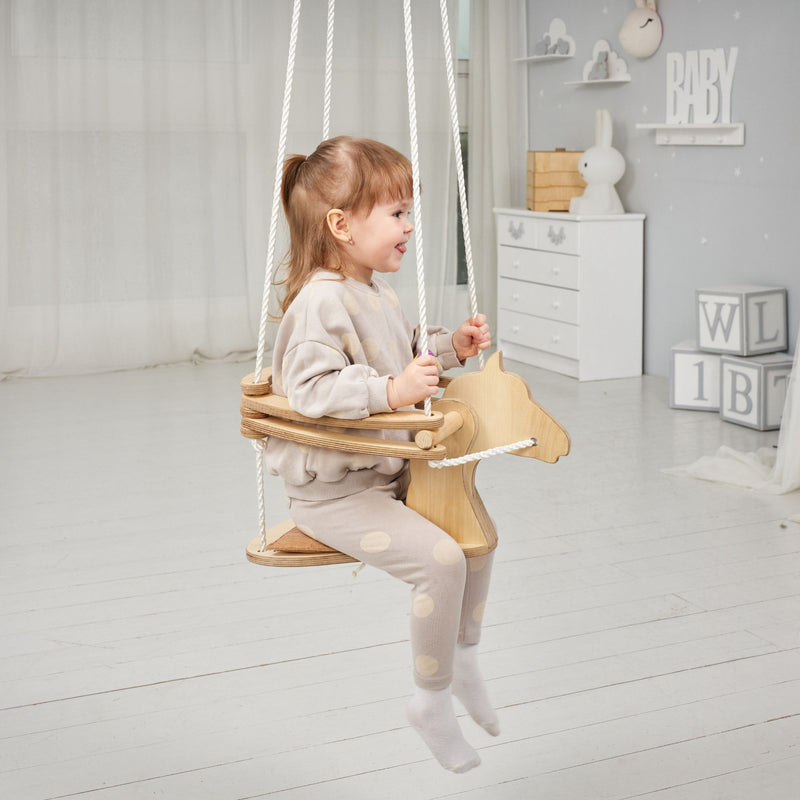 Little girl loving her gift - the Goodevas Montessori Horse Rope Swing | Montessori Activities For Babies & Kids - Clair de Lune UK