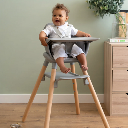 Baby sitting in the Grey 6in1 High chair by the sideboard in the kitchen | High Chair | Baby Feeding Essentials - Clair de Lune UK