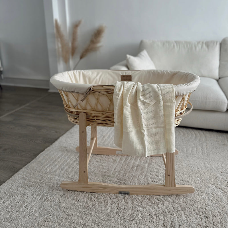 Gold Award Winning cream Organic Natural Wicker Moses Basket on Natural Rocking Stand in a customers home with organic cream blanket | Moses Baskets | Co-sleepers | Nursery Furniture - Clair de Lune UK