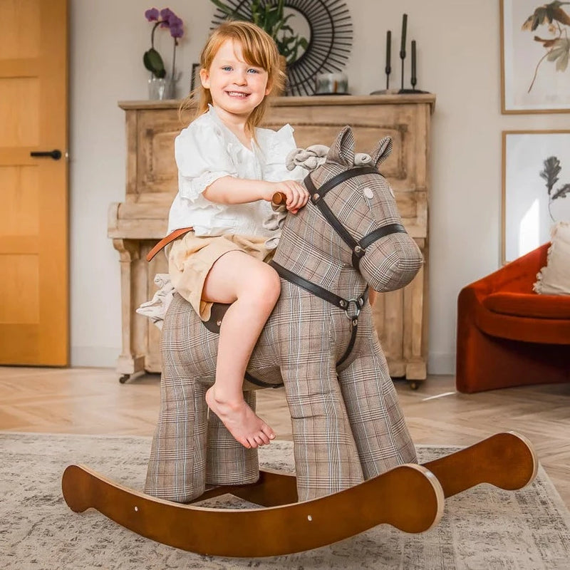 Little girl smiling while riding her Little Bird Told Me Jasper Rocking Horse | Rocking Animals | Montessori Activities For Babies & Kids | Toys | Baby Shower, Birthday & Christmas - Clair de Lune UK