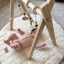 Tiny newborn baby Lying on the Organic Play Mat & Playing with toys on the Wooden Play Gym Set | Baby Play Mats & Gyms | Baby Tummy Time Toys - Clair de Lune UK