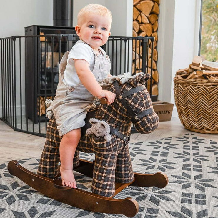 Toddler boy riding his Little Bird Told Me Rufus & Ted Rocking Horse in a cosy traditional British cottage | Rocking Animals | Montessori Activities For Babies & Kids | Toys | Baby Shower, Birthday & Christmas - Clair de Lune UK