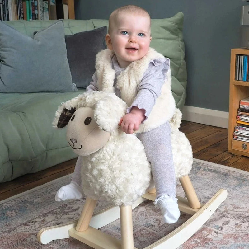 Toddler girl riding her favourite toy Little Bird Told Me Lambert Rocking Sheep in a traditional British cottage | Rocking Animals | Montessori Activities For Babies & Kids | Toys | Baby Shower, Birthday & Christmas - Clair de Lune UK