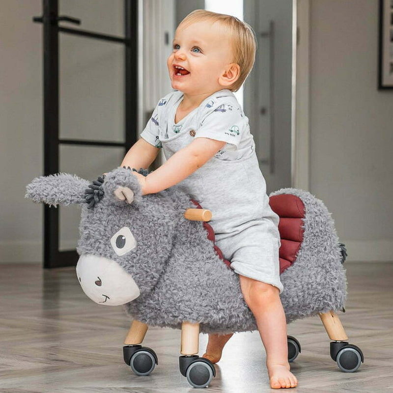 Toddler happy racing on his his Little Bird Told Me Bojangles Donkey Ride On Toy | Baby Walkers and Ride On Toys | Montessori Activities For Babies & Kids | Toys | Baby Shower, Birthday & Christmas Gifts - Clair de Lune UK