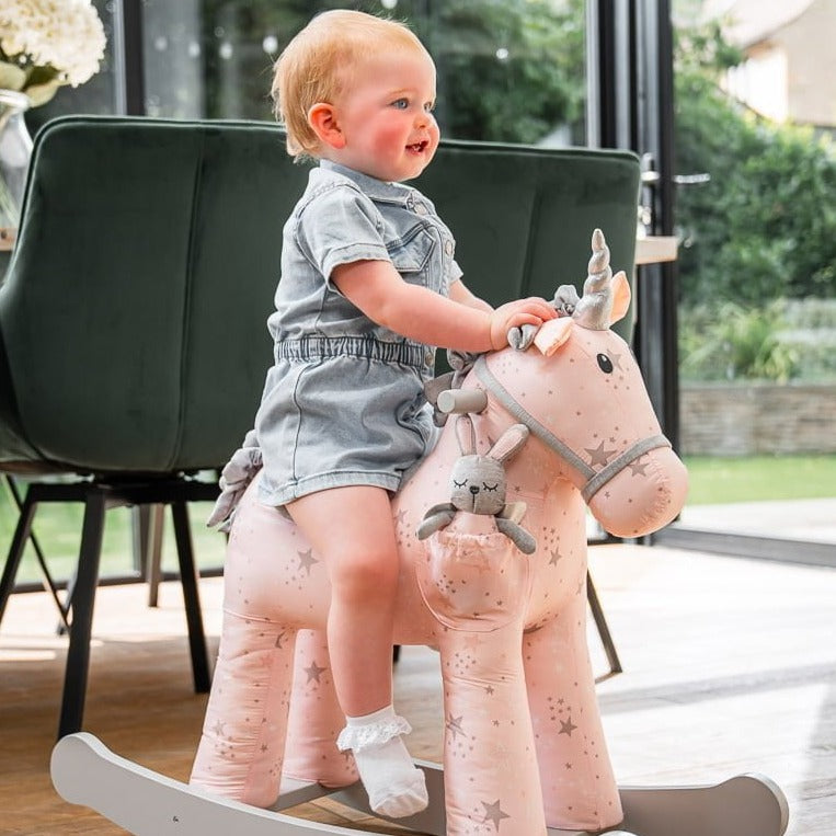 Toddler riding her pink Little Bird Told Me Celeste & Fae Rocking Unicorn | Rocking Animals | Montessori Activities For Babies & Kids | Toys | Baby Shower, Birthday & Christmas - Clair de Lune UK