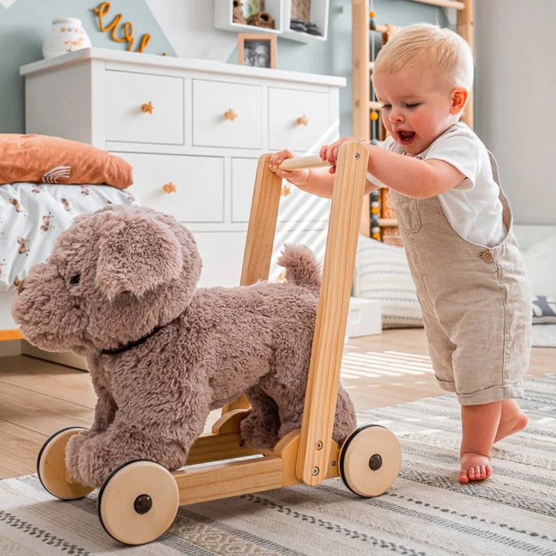 Toddler pushing the Little Bird Told Me Bailey Dog Push Along, Baby Walker and Ride On in a natural Scandi nursery | Montessori Activities For Babies & Kids | Toys | Baby Shower, Birthday & Christmas Gifts - Clair de Lune UK